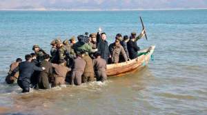 North Korean leader Kim Jong-Un waves while in a boat during his visit to the Wolnae Islet Defence Detachment in the western sector of the front line, which is near Baengnyeong Island of South Korea